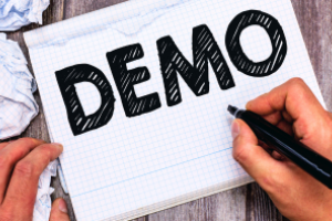 Iemand schrijft met een zwarte stift DEMO op een kladblok